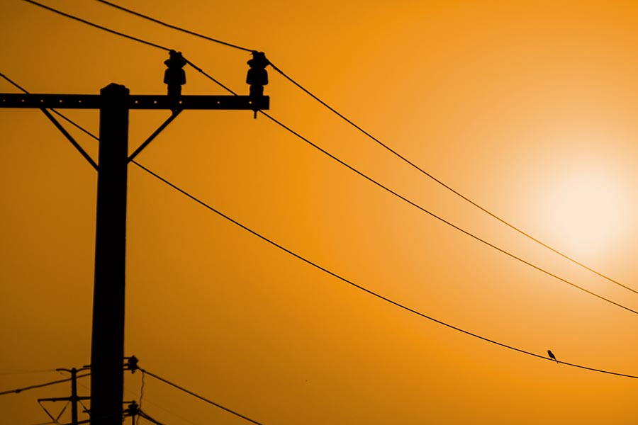 Power lines on a hot day in the sun can be shut down if there is a high risk of fire.